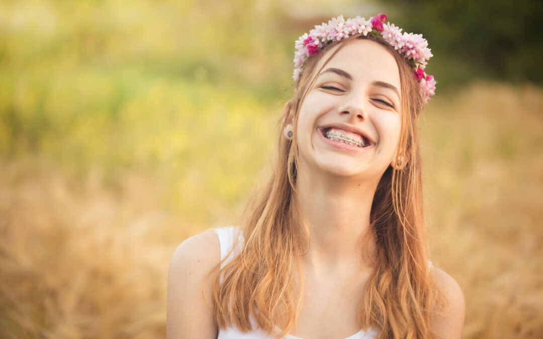 Young teen with braces smiling during summer vacation